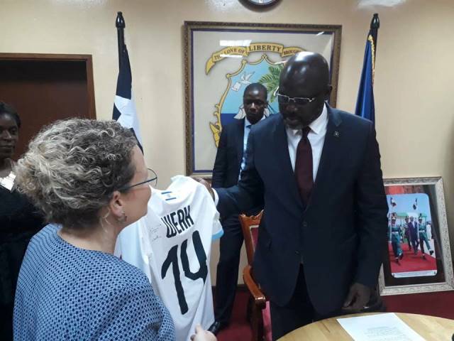 Amb. Cooper presenting a jersey to Liberian President George Weah